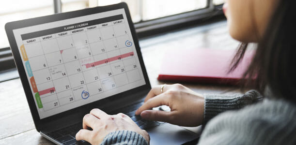 Woman Using Computer Calendar